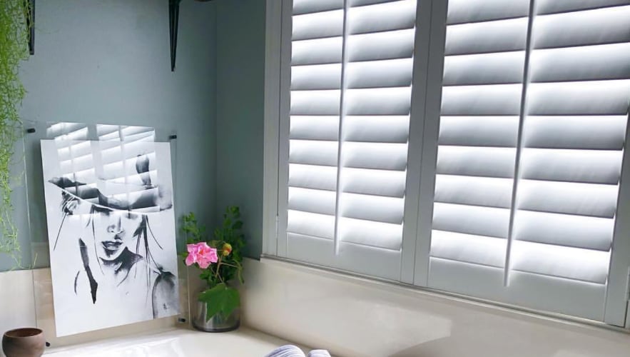 Plantation shutters in a bathroom window